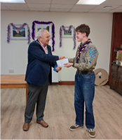 Richmond Rotary President Jos Huddleston presenting a cheque for £500 to Thomas Gibbons.